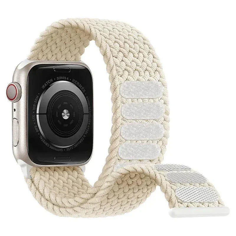 Elastic braided Apple Watch strap on a neutral background
